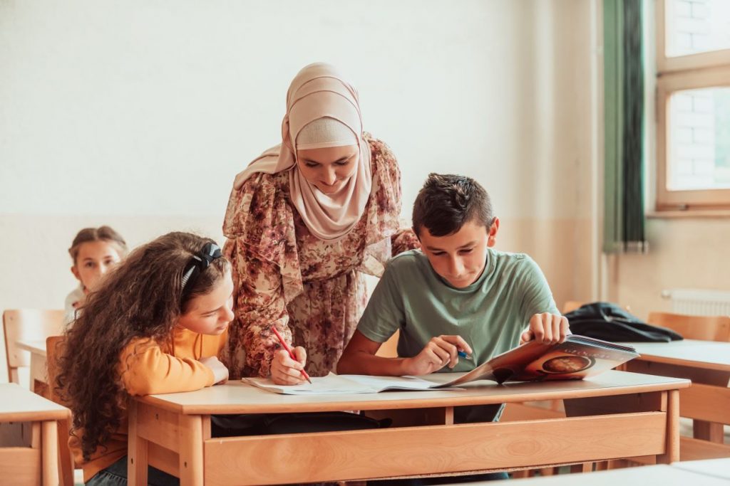 Woman assisting students