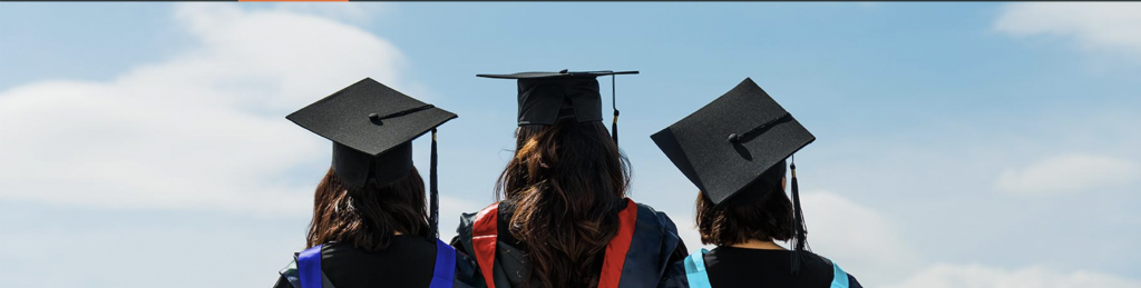 Three graduates in caps and gown.