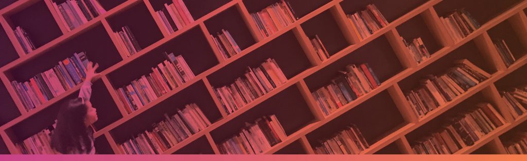 Child reaching for book off of shelf