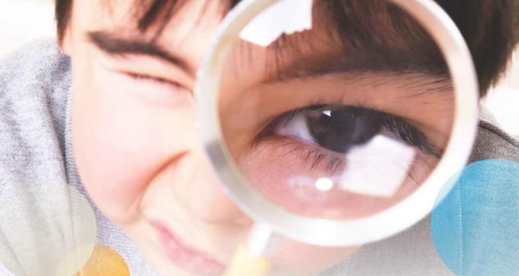 Child with magnifying glass