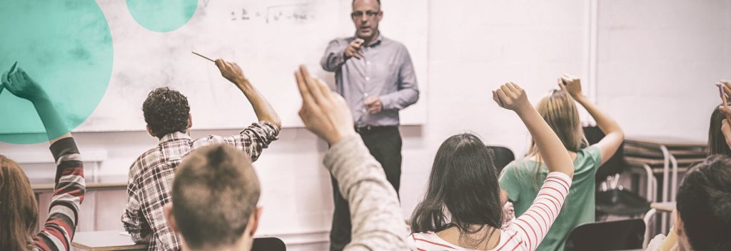 Teacher in front of class, students' hands up