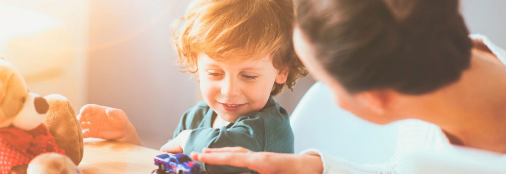 Child and stuffed animal with teacher