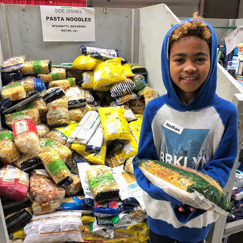 Child at food bank helping