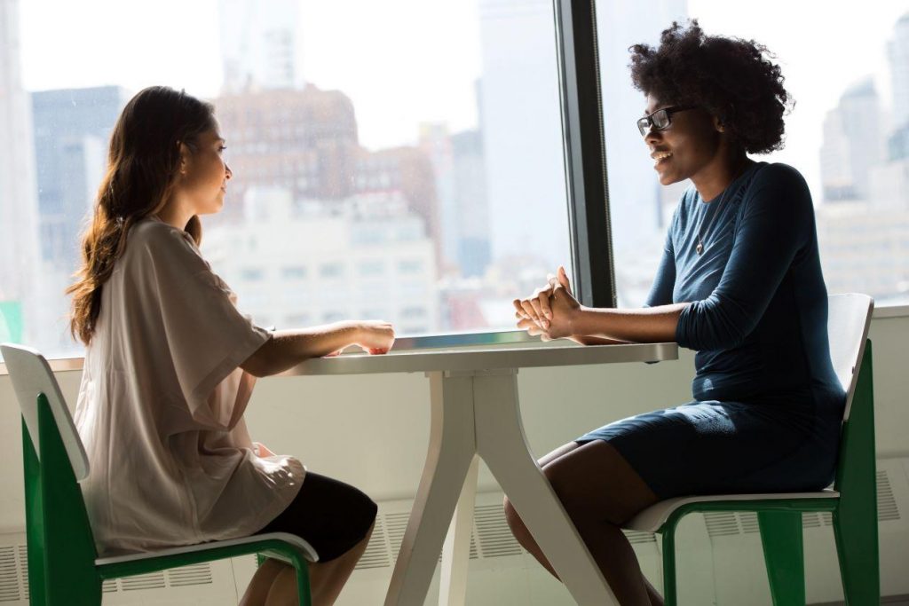 Two young women sitting together.