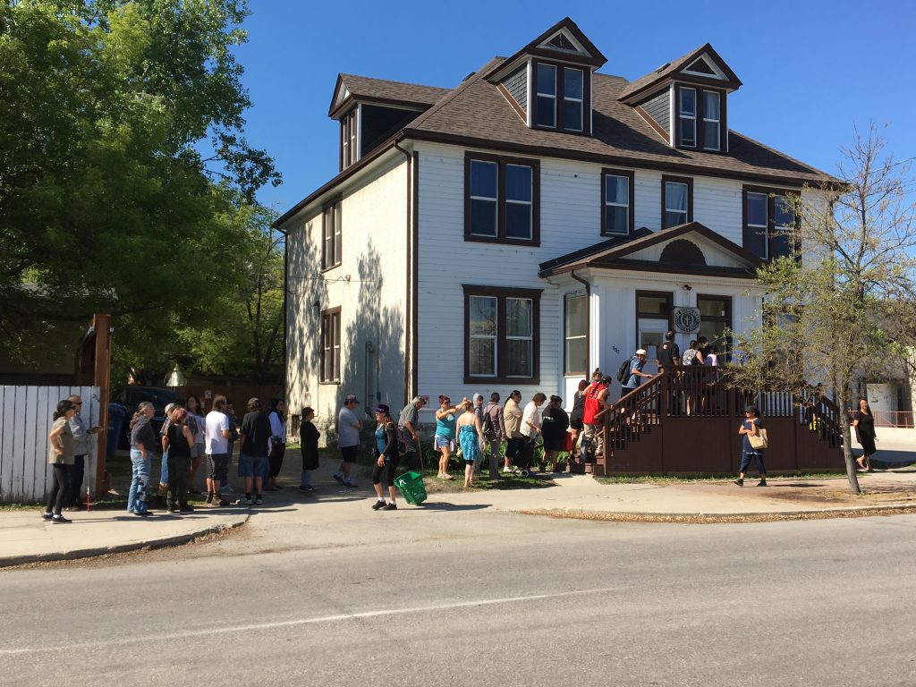 Lineup of people to view historical home